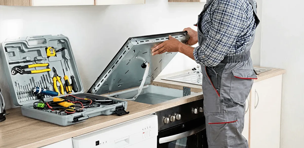 Handyman repairing a cooktop and checking wiring connections in Nashville, TN