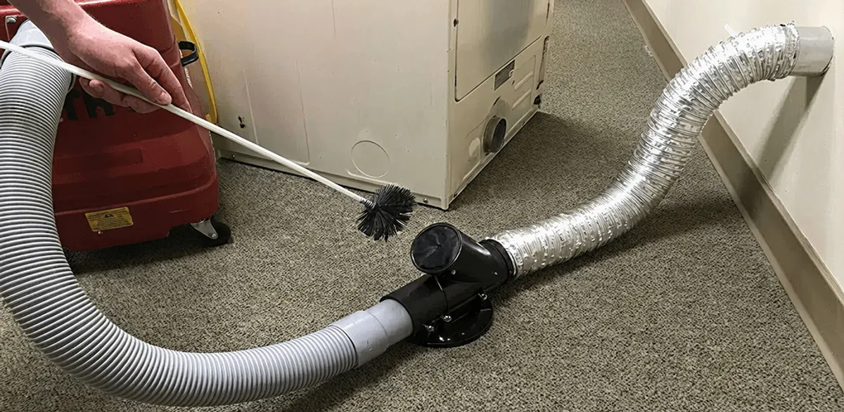 Dryer vent cleaning service removing lint from a dryer duct connection in Nashville, TN