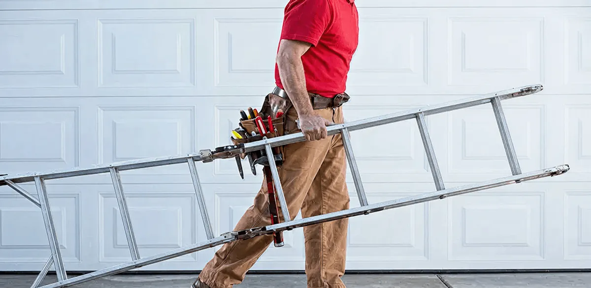 Garage door repair technician arriving with tools and ladder in Nashville, TN