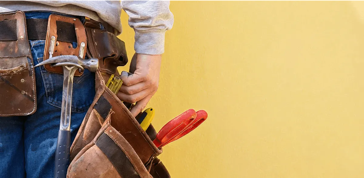 Handyman with tool belt ready for home repairs and maintenance in Nashville, TN